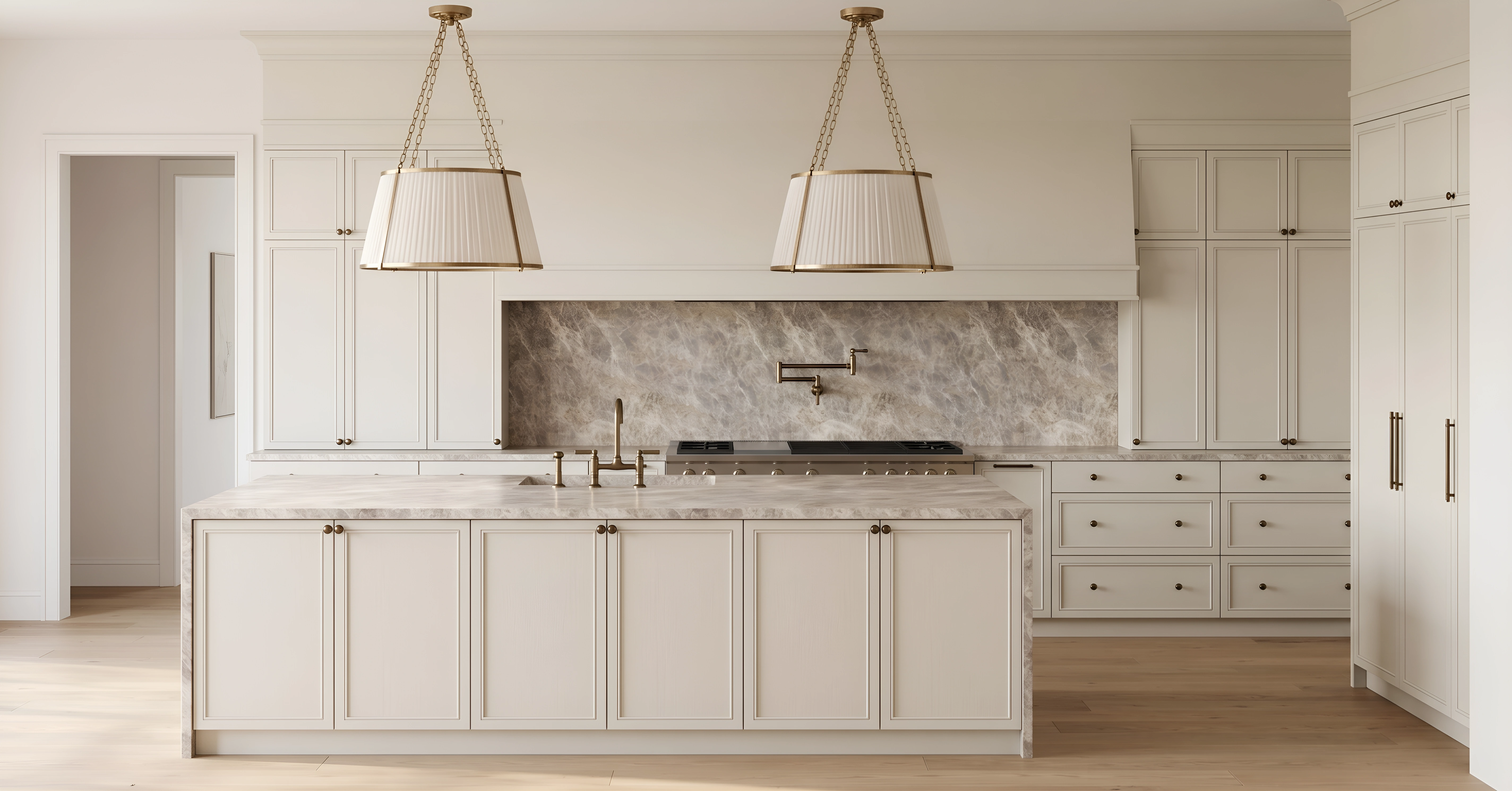 Kitchen with pleated brass pendant lights and marble backsplash designed by Chelsey Rain Interiors